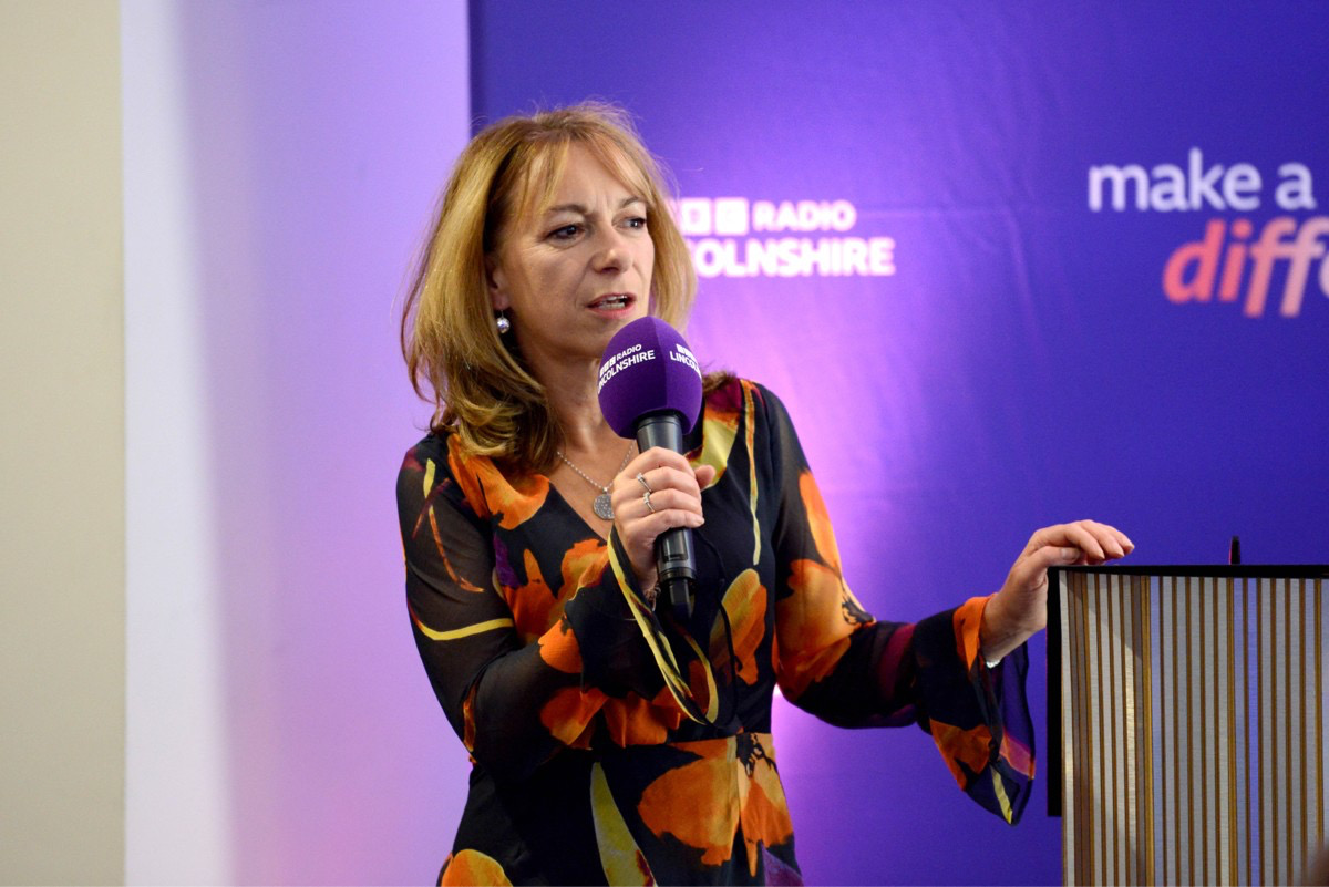 Maggie Curtis holding a BBC Radio Lincolnshire microphone